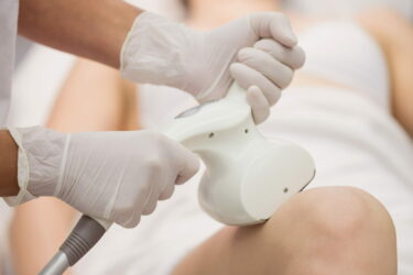 Woman getting anticellulite and anti fat therapy in clinic Woman getting anticellulite and anti fat therapy in clinic